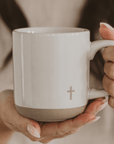 Faith-inspired cross stoneware mug in cream with natural bottom – dishwasher and microwave safe