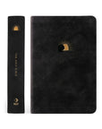 Compact NLT Jerusalem Bible showing the front cover and spine with gold sunrise artwork on a black suede-like cover.