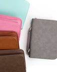 Four bible cover options in pink, brown, and gray on a white background