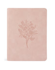 A blush pink suede ESV journaling Bible with a floral design embossed on the cover.