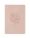 A blush pink suede notebook with a floral embossed design on the cover.