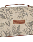 Angled view of Amazing Grace natural canvas Bible cover showing the floral screen-printed design