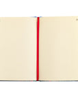 Open Cana Christian notebook showing lined journal pages with red ribbon marker for prayer, notes, and Bible study