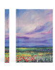 Cana Christian notebook showing spine and front cover with purple and blue landscape design and colorful wildflowers