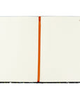 Open spread of the Coram Christian journal showing cream lined pages with a rust-orange ribbon bookmark, perfect for Bible study notes, prayer journaling, and quiet-time reflections.