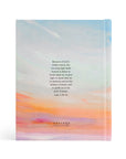 Back cover of Rosemary Beach NLT journaling Bible featuring Luke 1:78-79 with soft sunrise sky design