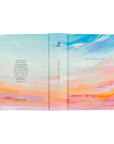 Full wrap cover of Rosemary Beach NLT journaling Bible showing front, spine, and back with colorful sunrise sky design