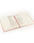 Open Rosemary Beach NLT journaling Bible shown at an angle displaying lined margins and ribbon marker