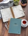 Teal spiral bound KJV journaling Bible laying flat with wide margins for notes, illustrations, and creative Bible study