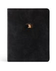 Black leather-like cover of the CSB Notetaking Bible with a gold-foiled illustration of the open tomb on the front, symbolizing Christ's victory over death.