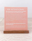 A wooden stand holding a pink inspirational card with text, part of the Worthy Collection.