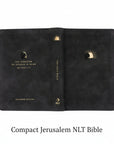 Black NLT Compact Jerusalem Bible with gold text and design laid  flat. 