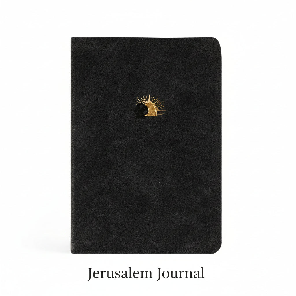 A black leather-like notebook with a gold-foiled illustration of Jesus&#39;s open tomb on the cover.