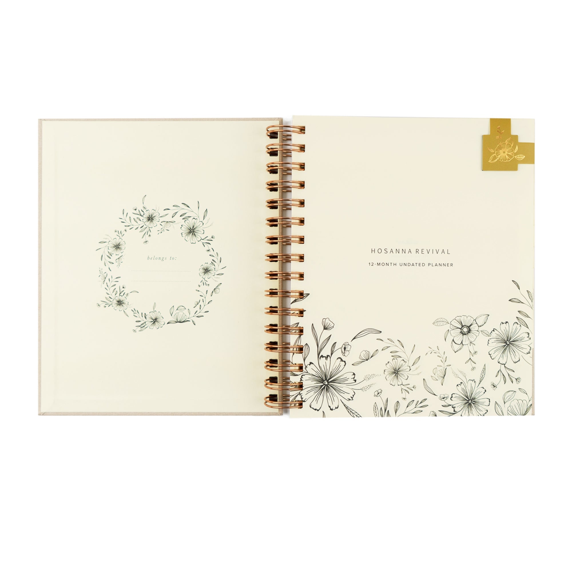 Open planner with floral designs and a belongs to page with magnetic bookmark. 