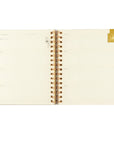 Open spiral-bound notebook with lined pages on a white background showing weekly view. 