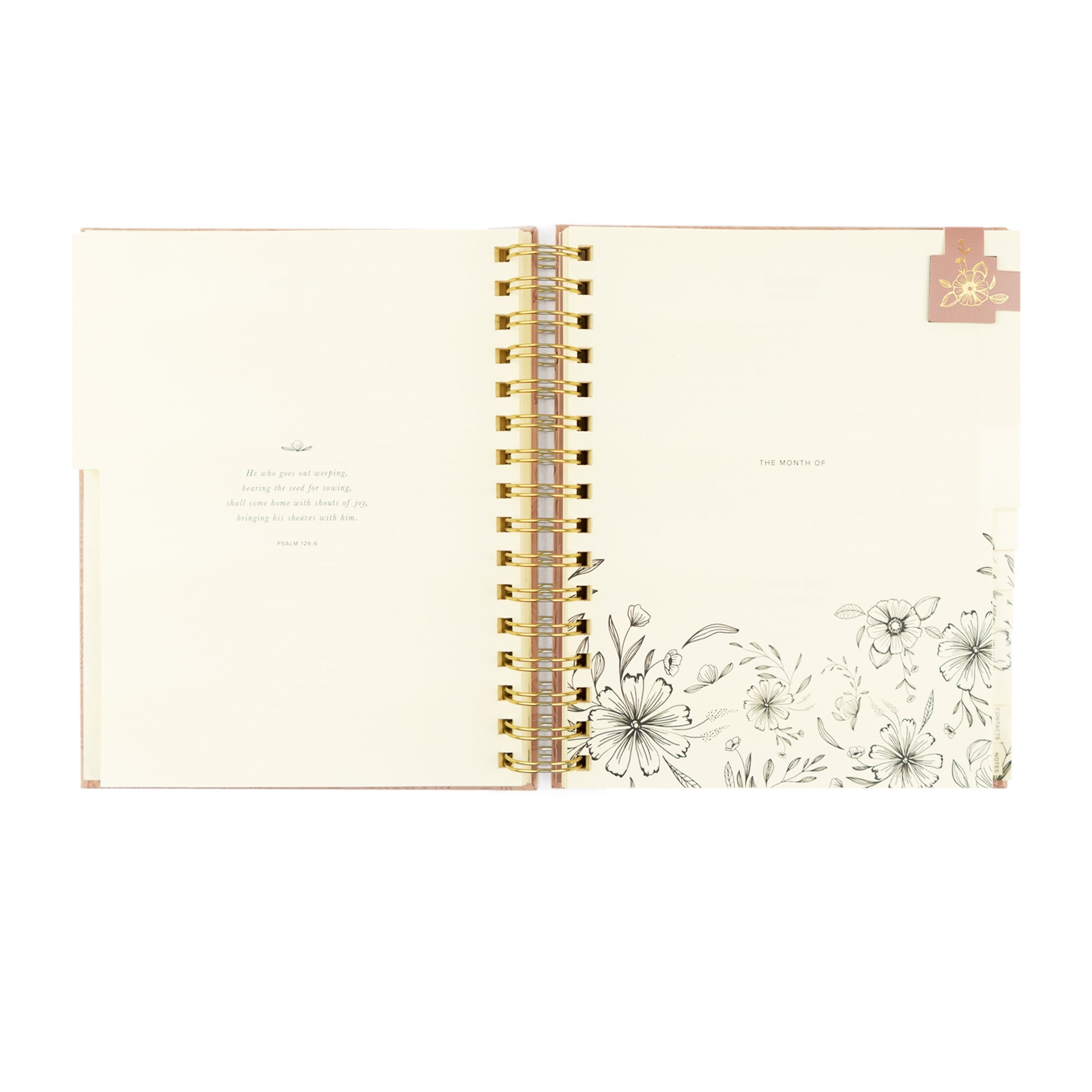Open faith-based undated Hosanna Revival pink planner with a view of the month and  pink magnetic bookmark. Monthly bible verse shown. 