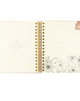 Open faith-based undated Hosanna Revival pink planner with a view of the month and  pink magnetic bookmark. Monthly bible verse shown. 