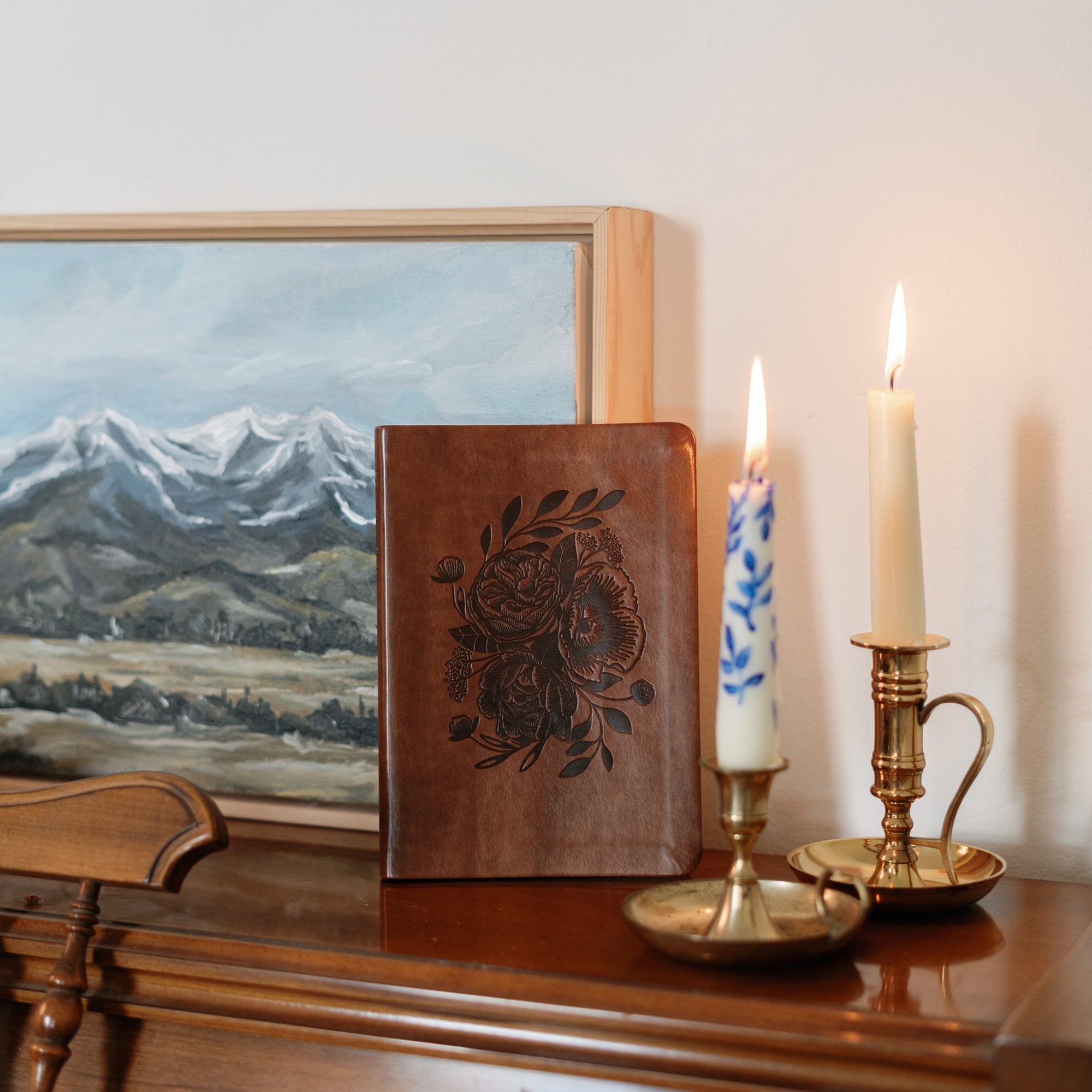 Aurora Christian notebook journal with floral embossed design on brown leather-like cover styled in home setting with candles for prayer journaling, Scripture reflection, and daily devotion