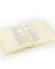 Angled open Belfast NLT journaling Bible showing wide lined margins and single-column layout