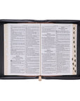 Interior view of Blessed black croc faux leather Bible cover laid open with Bible inside, showing pen loops, zipper, and interior organization