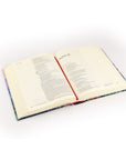 Cana NLT journaling Bible open at an angle showing Scripture text and wide lined margins for note-taking