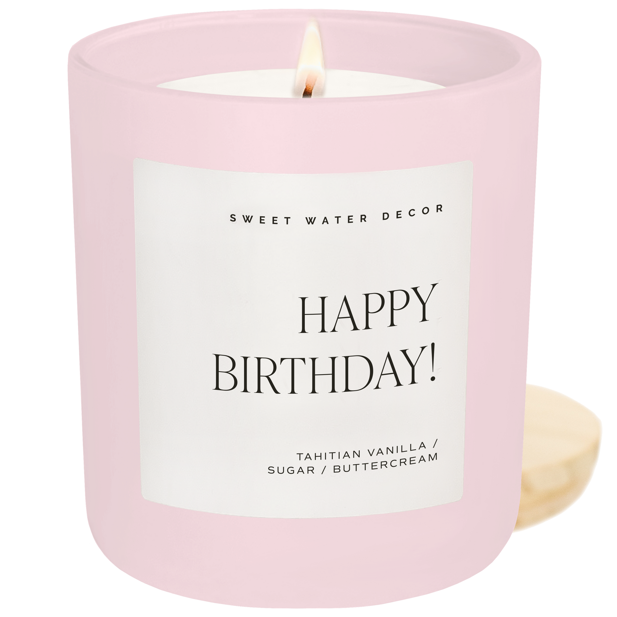 Happy Birthday candle in pink jar with Tahitian vanilla and buttercream scent on white background