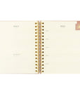 Pink floral Christian planner undated with month and weeks at a glance. Also space for monthly goals. Pink magnetic bookmark shown as well. 