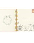 Open undated Christian planner by Hosanna Revival with belongs to page and pink magnetic bookmark on display.