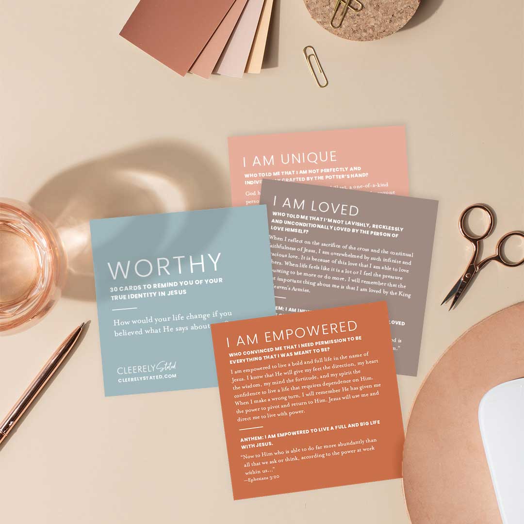 Lifestyle photo of Christian Identity Scripture Cards laid out on a desk, featuring cards titled Worthy, I Am Loved, I Am Unique, and I Am Empowered—designed to remind believers of their identity in Christ through encouraging Bible truths.