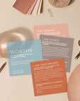 Lifestyle photo of Christian Identity Scripture Cards laid out on a desk, featuring cards titled Worthy, I Am Loved, I Am Unique, and I Am Empowered—designed to remind believers of their identity in Christ through encouraging Bible truths.