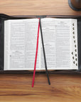 Open Crown of Thorns bible cover in large with ribbonsbible, marker, and a pencil on a wooden surface 