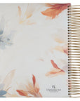 Back cover of Pearlized White Floral My Creative Bible KJV with watercolor florals and gold spiral binding