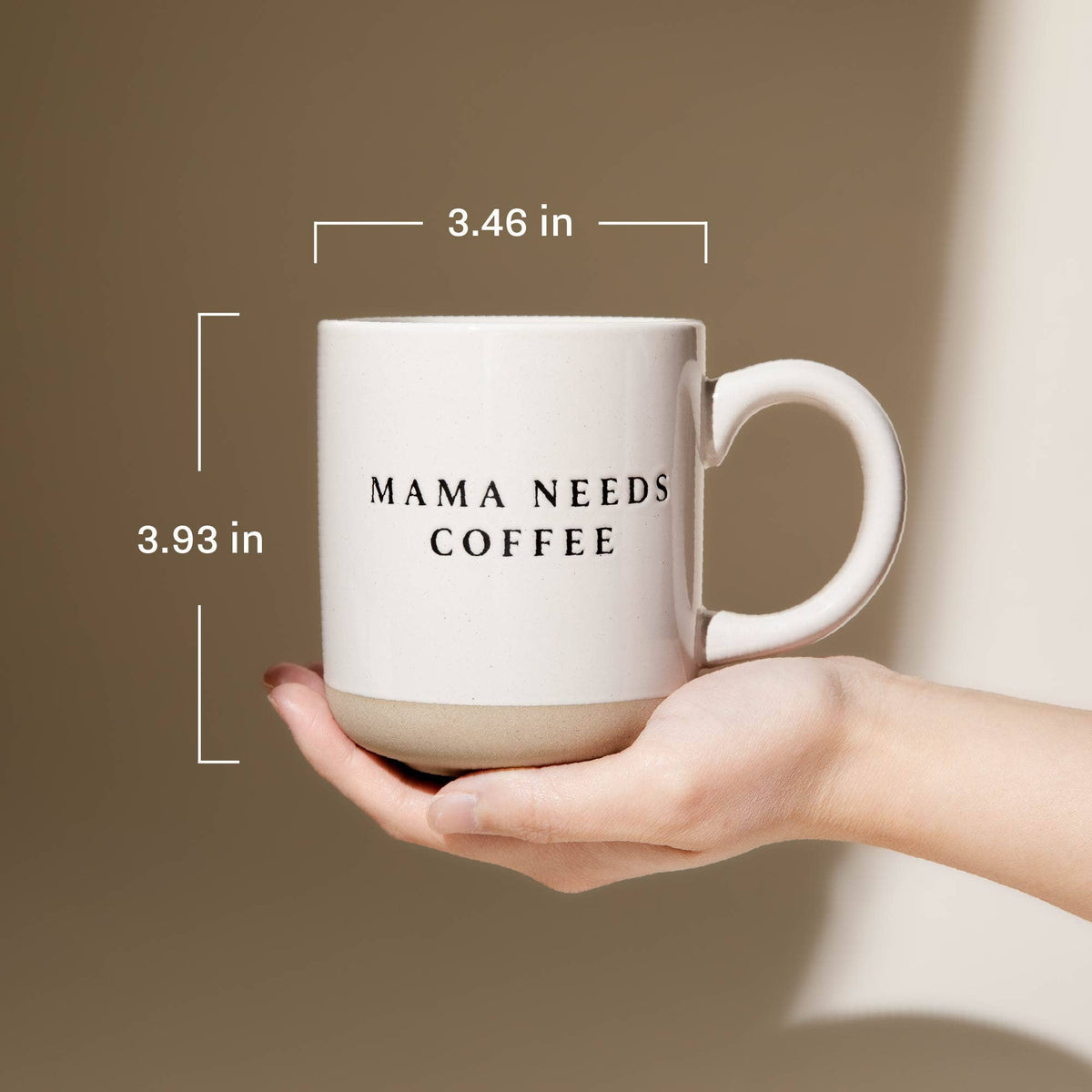 Hand holding a Mama Needs Coffee cream stoneware mug, with dimensions labeled 3.46 inches across and 3.93 inches tall.